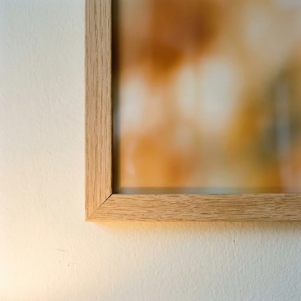 A plain wood mitre, plexiglass in front and the sheet full to the edge